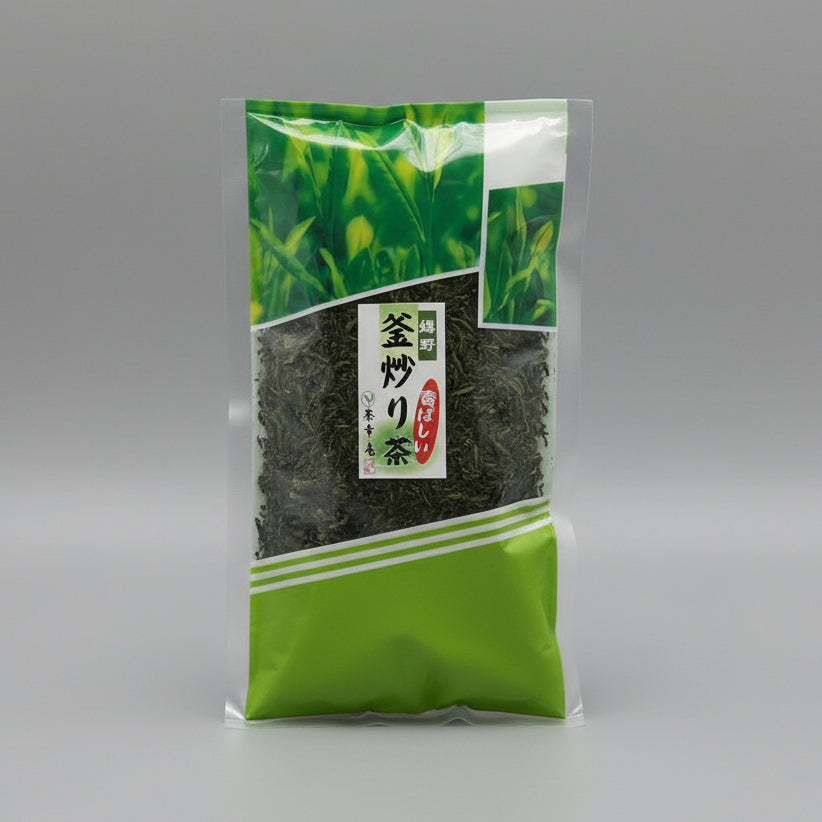 Packaged Ureshino Kamairicha green tea leaves in a clear plastic bag with green and white labeling.