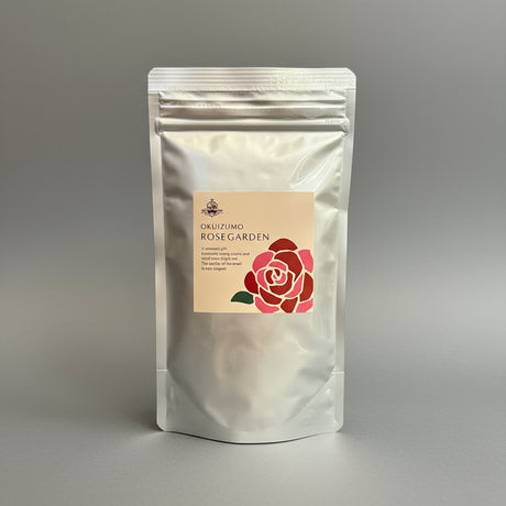 A sealed package of Okuizumo Rose Garden rose powder with a label featuring an illustration of a rose.
